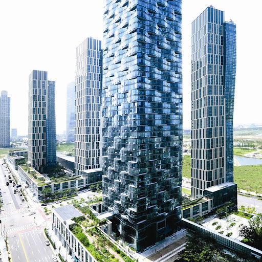 Skyscraper buildings with greenery, viewed from below